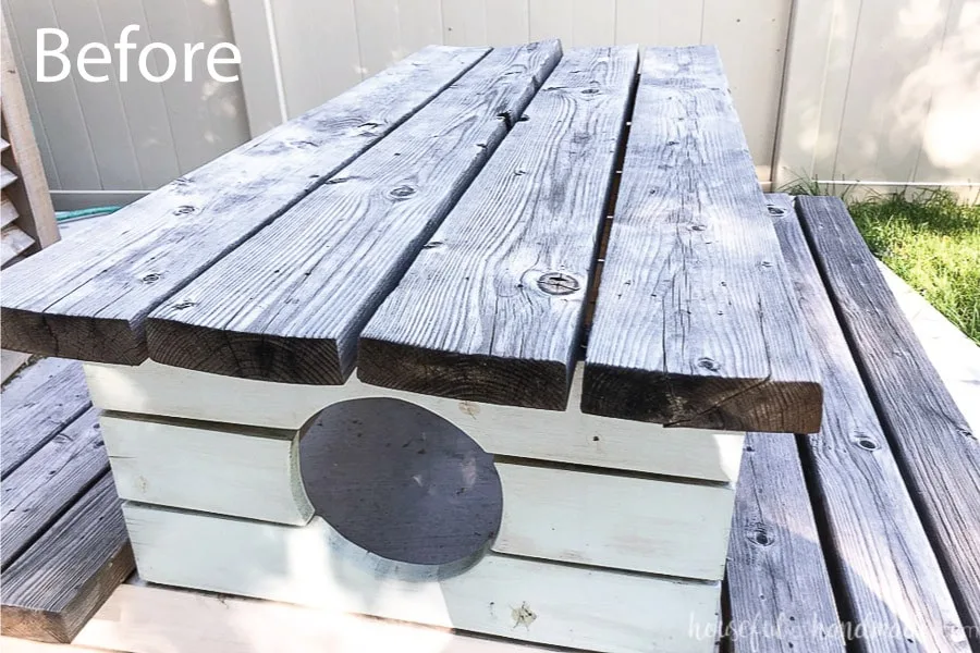 Close up of the warped table top boards on the picnic table before the makeover. 