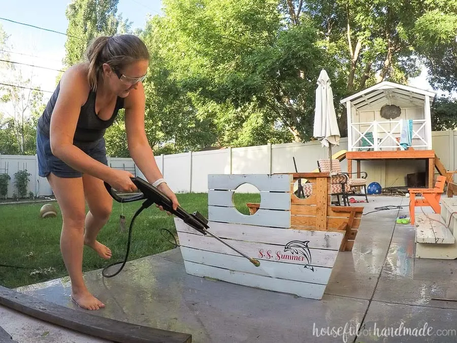 Power washing the dirt off the kids wooden picnic table. 