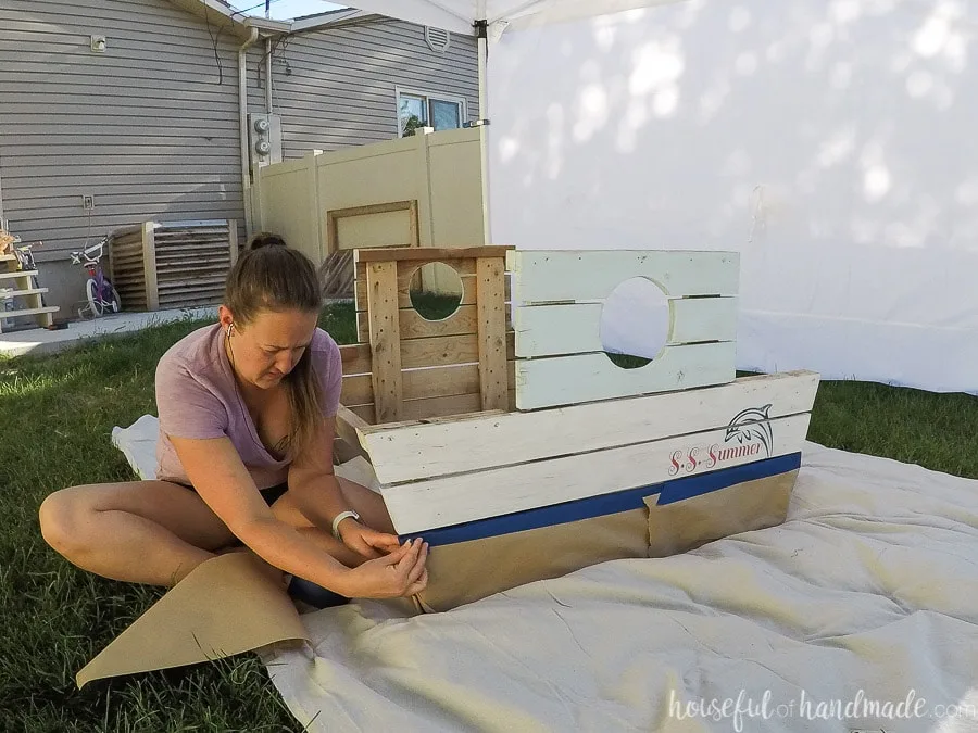 Taping off the lower two boards to paint an ombre sunset over the ocean. 