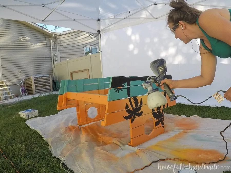 Sealing the painted picnic table with deep base. 