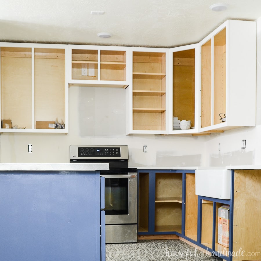 Kitchen remodel with handmade kitchen cabinets on the wall before cabinet doors are installed.