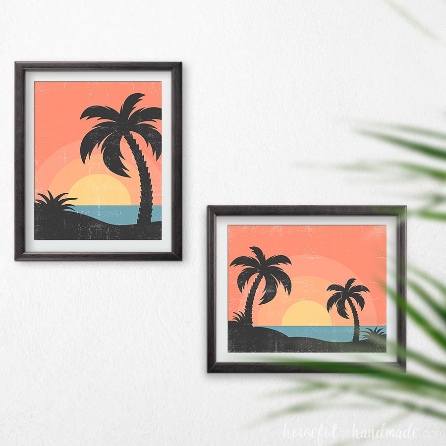 Two tropical sunset art prints in black frames hanging on the wall. 