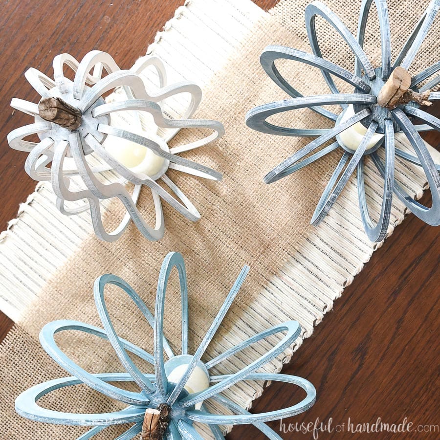 Top down view of the three 3D wood pumpkins and gourds painted with whites and blues.