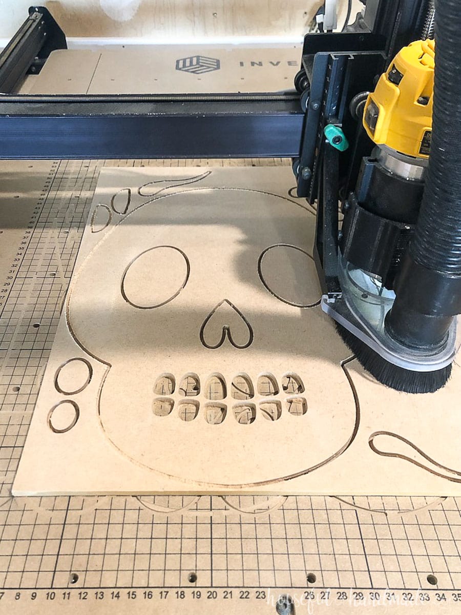 MDF being cut out into sugar skull pieces with a CNC machine. 