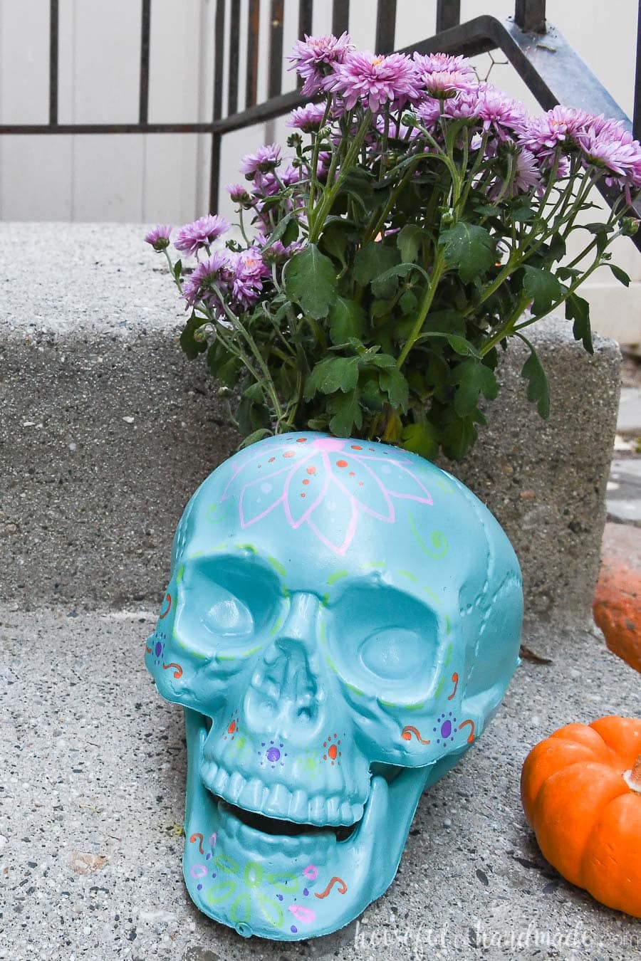 Blue halloween planter on a porch step.