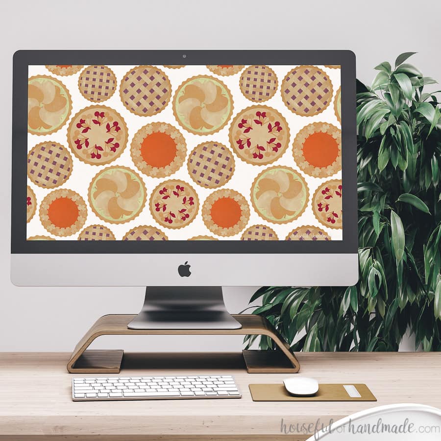 Desktop computer with free digital wallpaper for November on the screen.