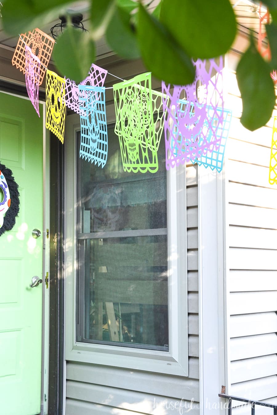 Looking toward the front door seeing the sugar skull paper banners hanging over the porch. 