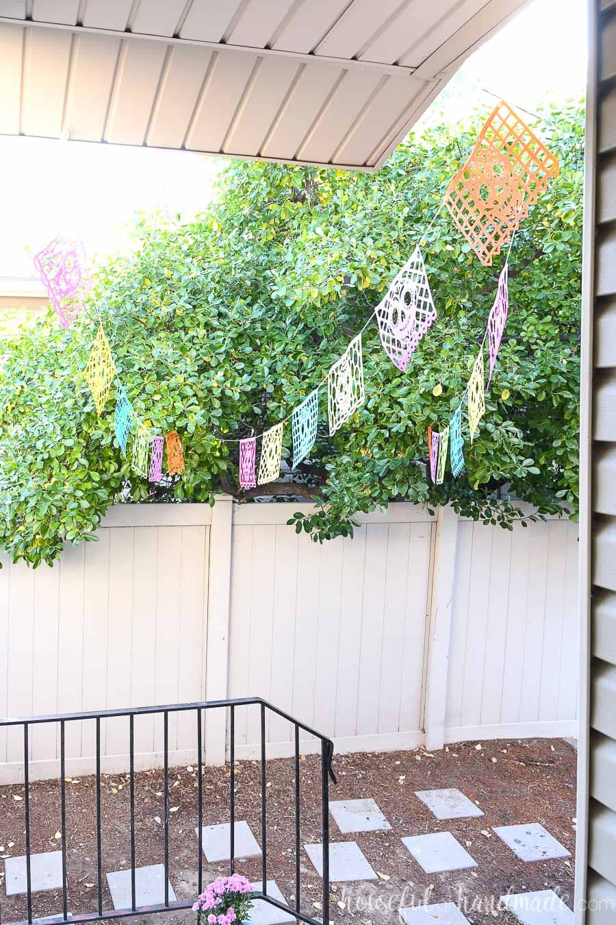 Looking out the front door at the paper day of the dead banners hanging over the porch. 