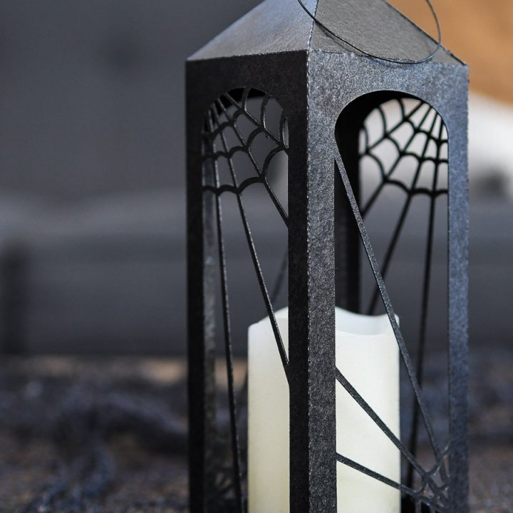 Close up view of the smallest black Halloween lantern with spiderweb decorations.