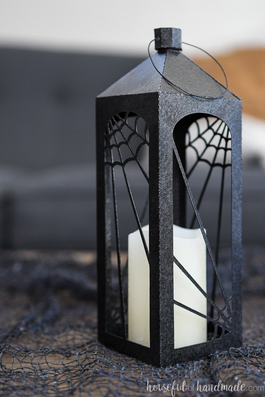 Close up view of the smallest black Halloween lantern with spiderweb decorations. 