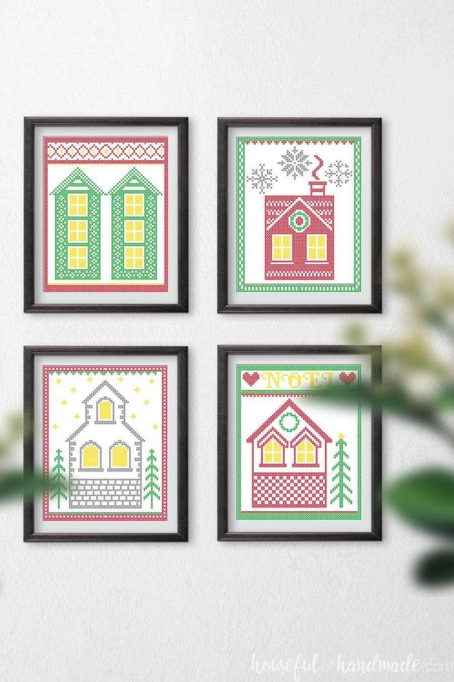 Wall with 4 Christmas printables in frames hanging on it. 