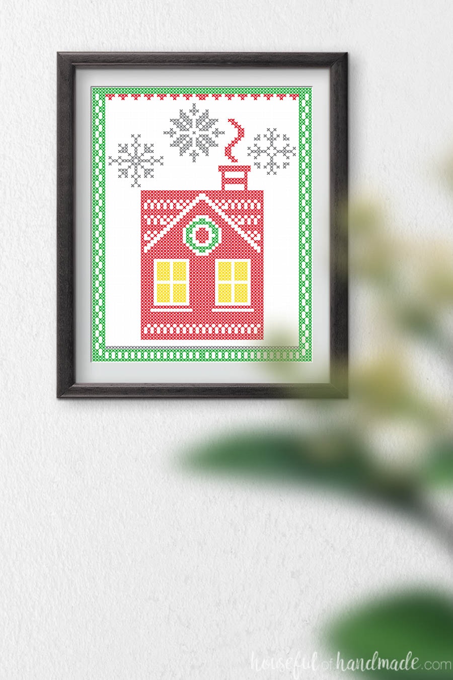 Printable Christmas art that looks like a Nordic Christmas house with cross-stitch snowflakes. 