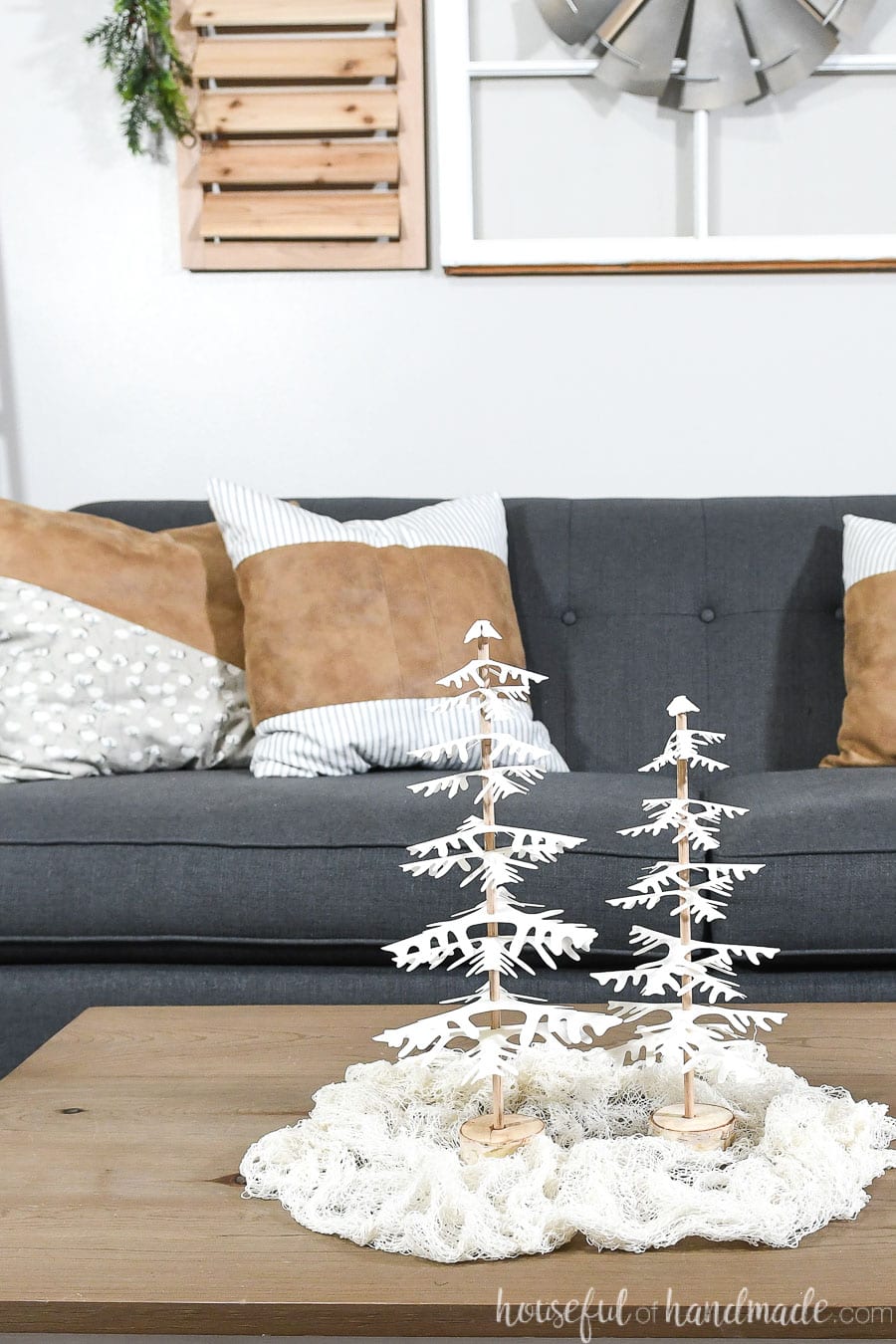 Coffee table decorated for Christmas with white DIY decorative Christmas trees.