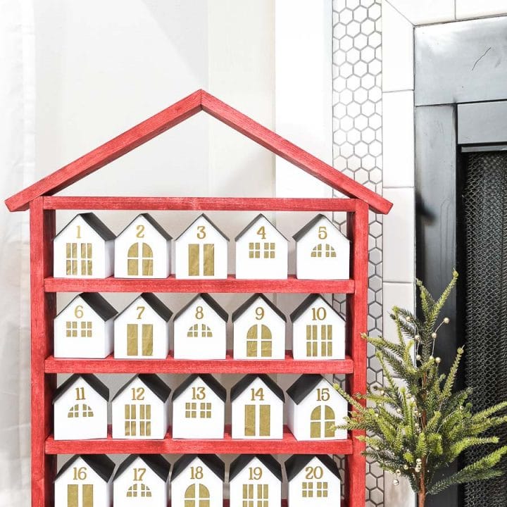 Red shelves with 25 white & gold paper houses on them to open each day in December until Christmas.