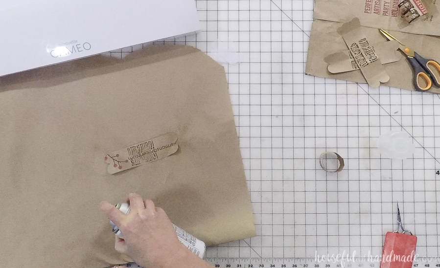 Adding spray glue to the back of the paper to make the napkin rings.
