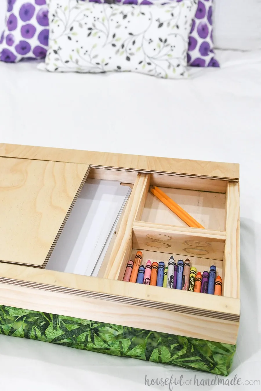 Lap desk with top slide off showing compartments for art supplies underneath. 