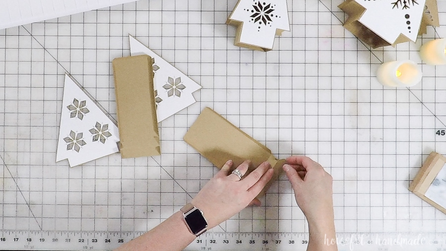 Folding the tabs on the lantern side pieces.