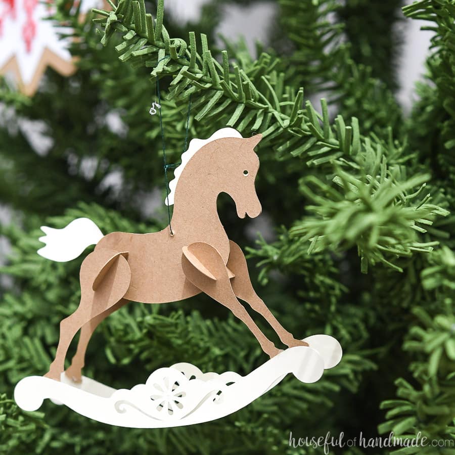 Small rocking horse ornament made out of paper.