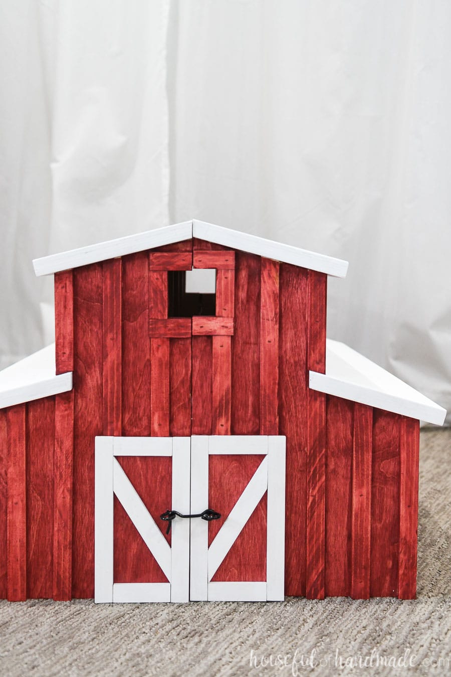 Front view of the toy barn build with lots of details and white trimmed barn doors. 