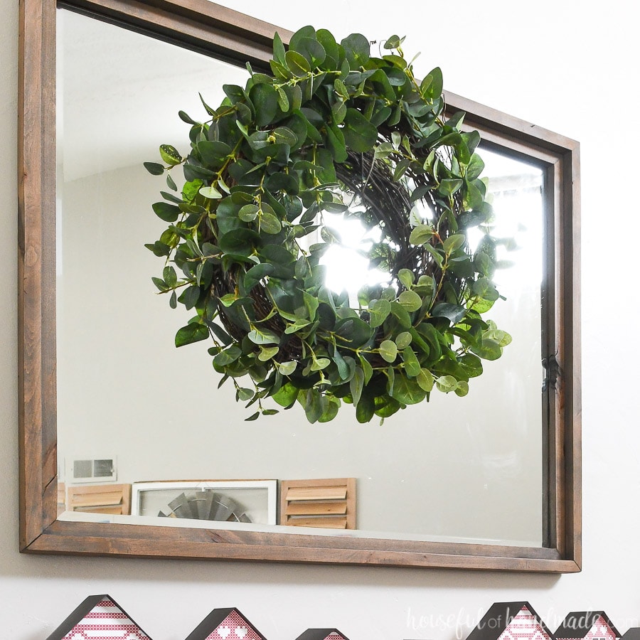 Easy DIY eucalyptus wreath hanging over a mirror above the mantel. 