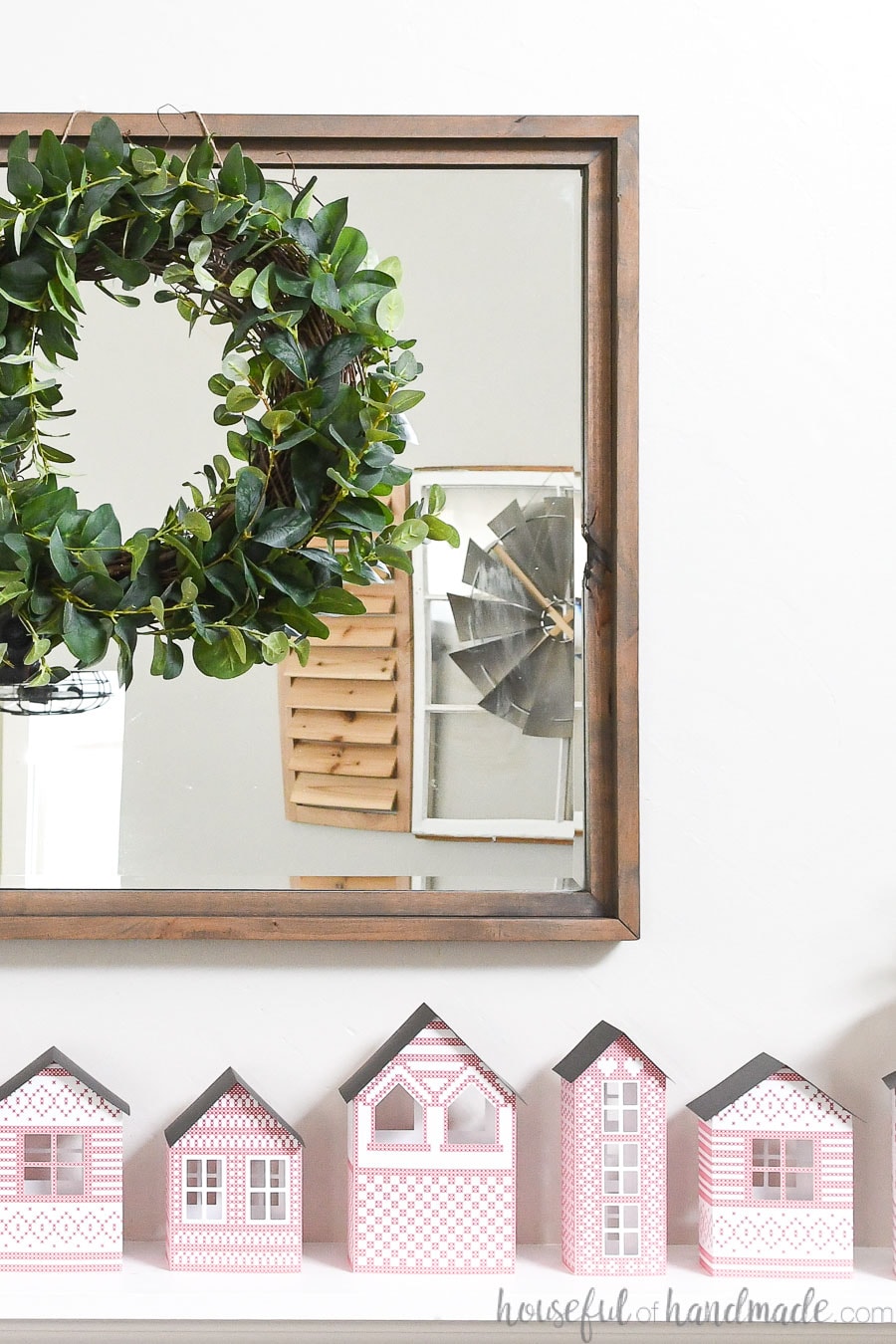 Christmas mantel with a paper Christmas village and easy to make eucalyptus wreath.