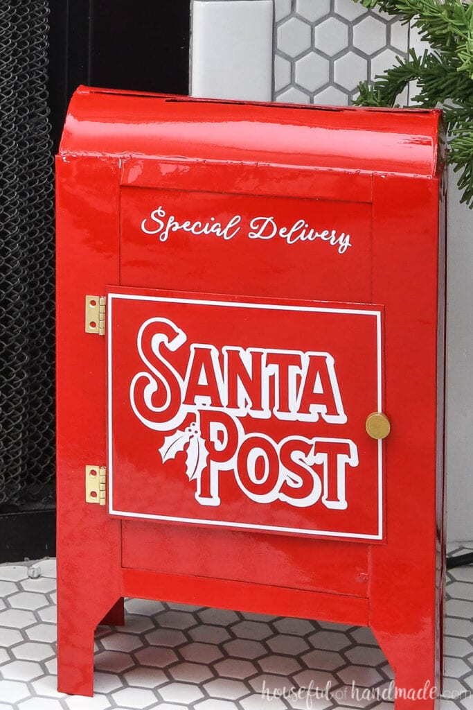 Close-up of the shiny red DIY Santa's mailbox with vinyl Santa Post design on the door. 