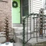 Two outdoor Christmas trees built from 2x4s on the front porch.