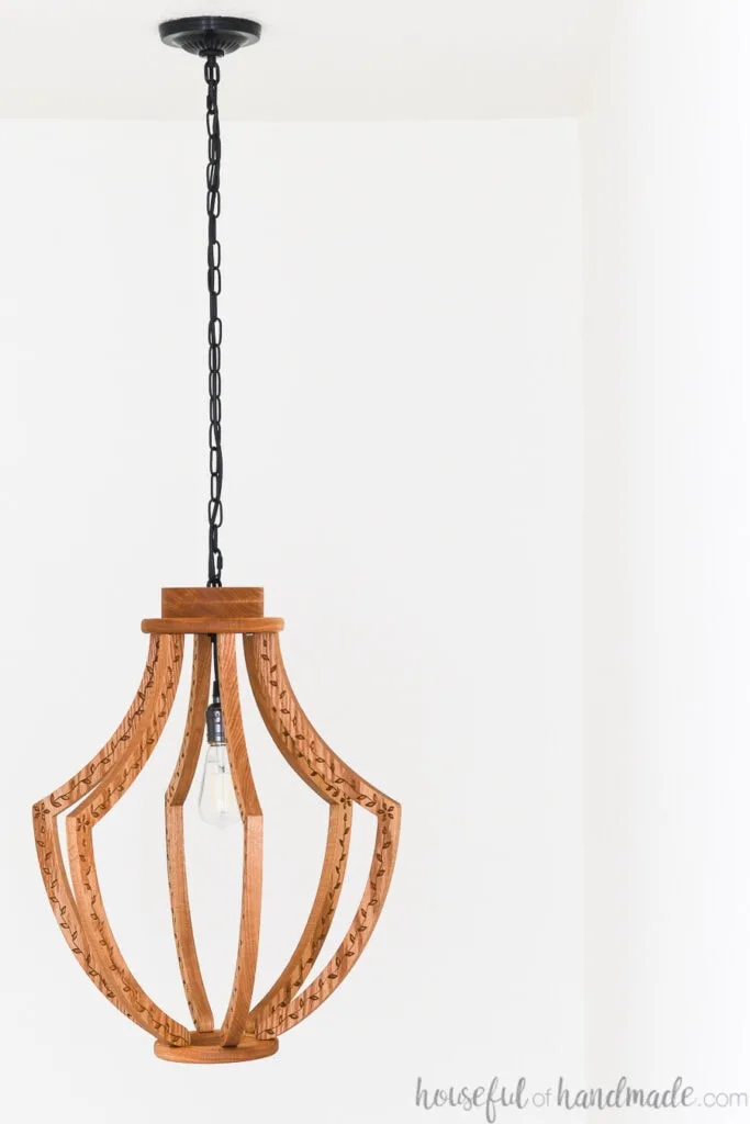 DIY chandelier made from wood hanging from the ceiling. 