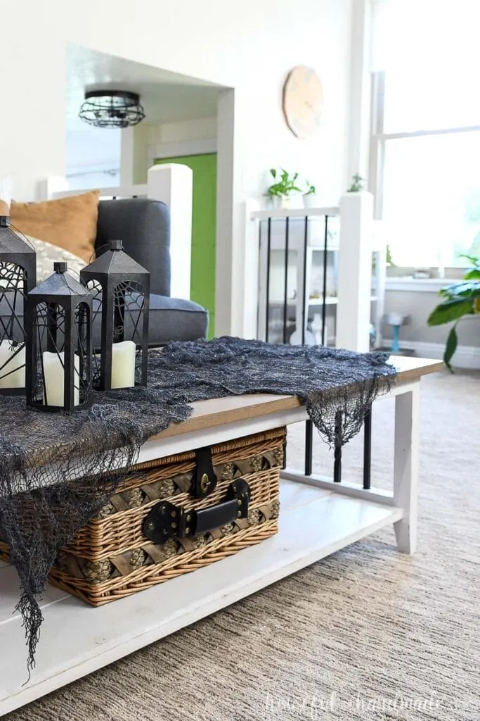 Thrifted basket under coffee table in a living room used as home storage. 