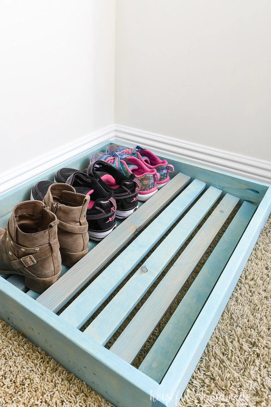 Shoe organizer tray with shoes on the back row showing the way the shoes sit in the organizer. 