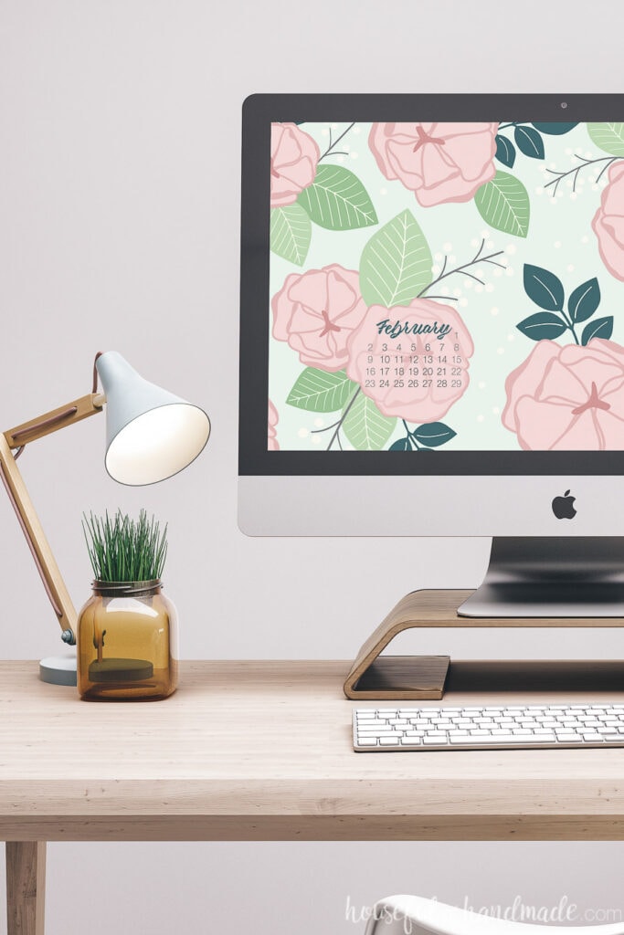 Desktop computer with the free digital wallpaper for February on the screen.