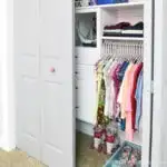 One door open showing the inside of the organized girls closet makeover done for only $100.