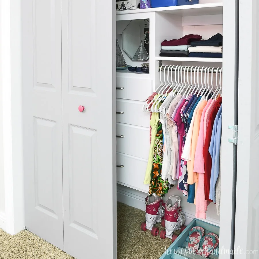 One door open showing the inside of the organized girls closet makeover done for only $100.