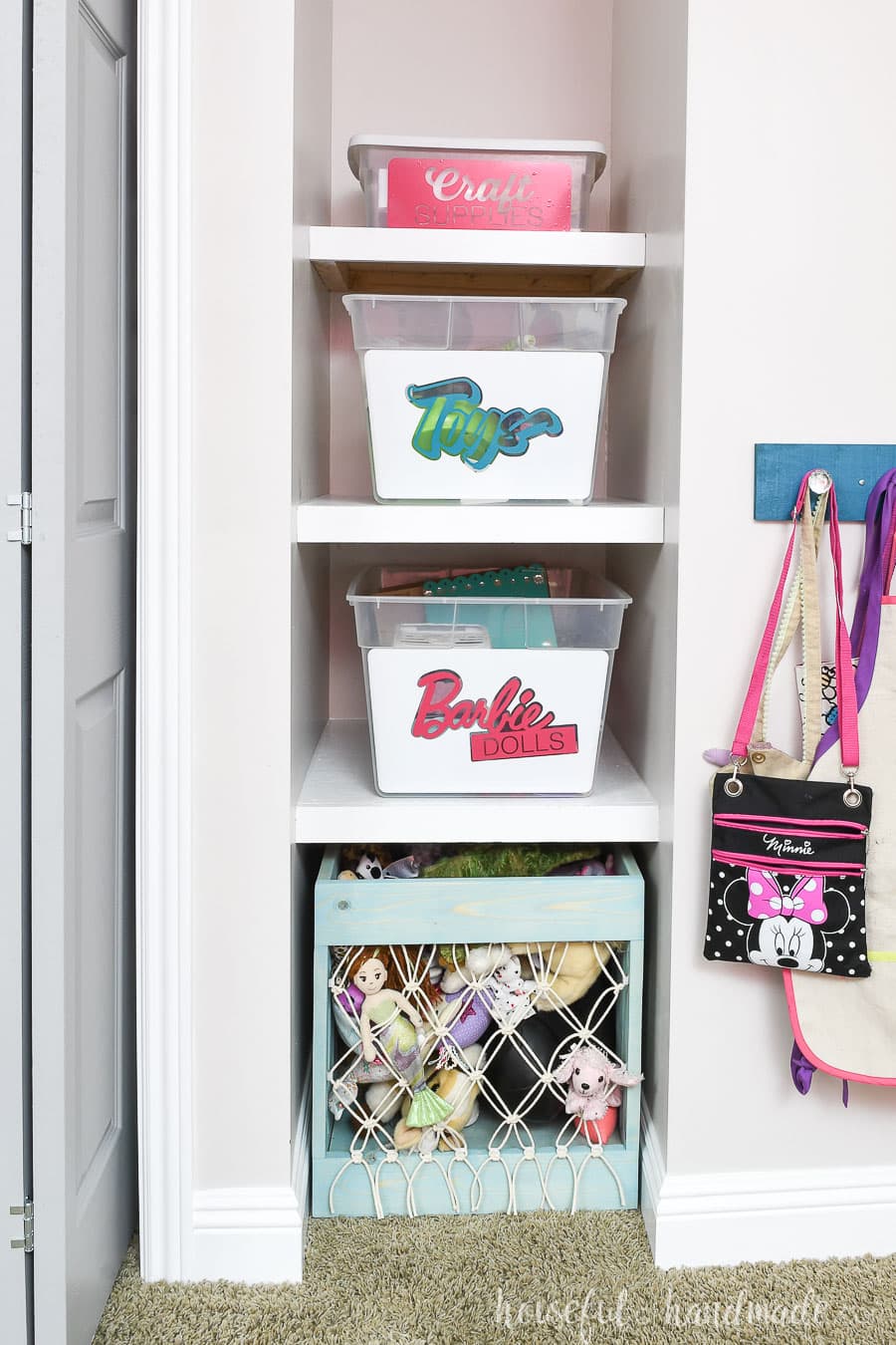 Shelf nook next to the closet with toys organized in bins.