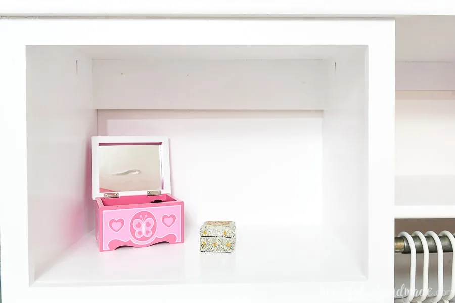 Close up view of the top open storage area on the closet system being used as a vanity space. 