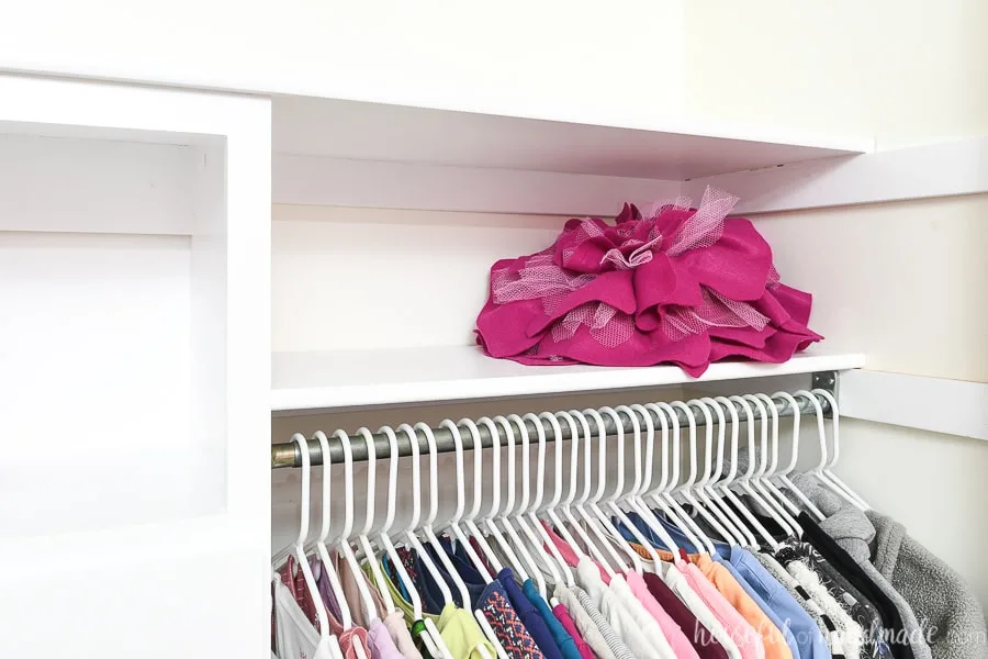 Close up view of the top shelf and the shelves added to the side of the closet organizer system.