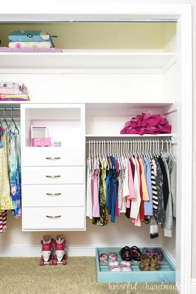 Clothing closet organized with DIY closet system with drawers.