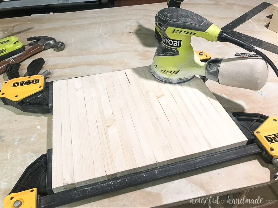 Sanding all the side slats at once with them clamped together. 