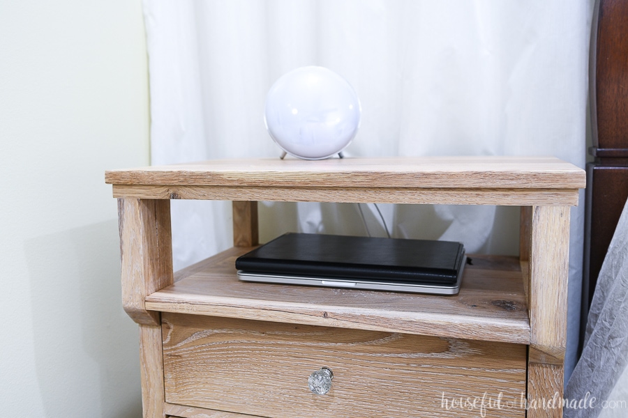 Close up of the open shelf on the top of the nightstand with beautiful details. 