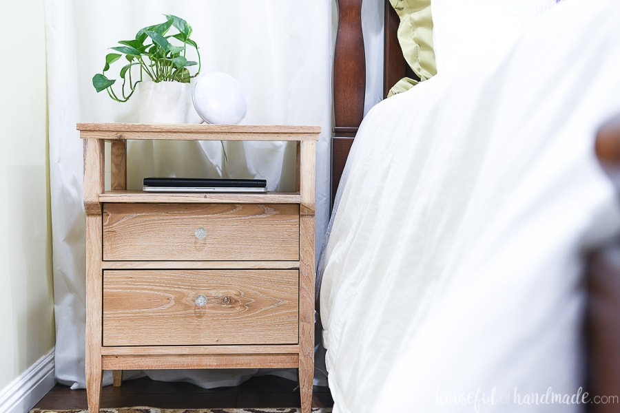 Tall nightstand with 2 drawers and open shelf for charging electronics or storing books.