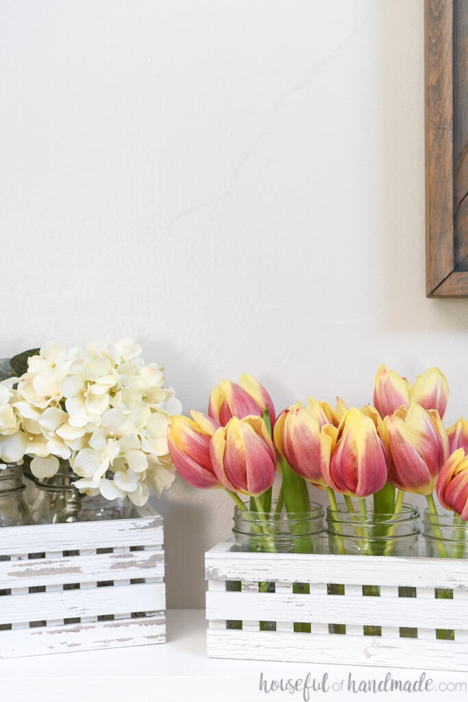Decorative faux wood trough boxes with flowers in them for spring.