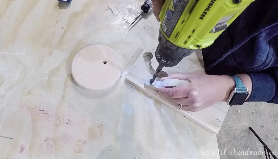 Drilling a hole on the underside of the top piece on the necklace holder. 