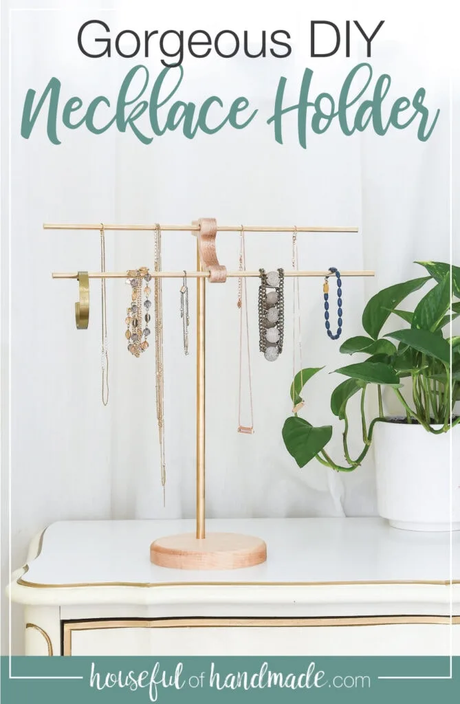 Brass and wood DIY necklace holder with necklaces and bracelets hanging on it. 