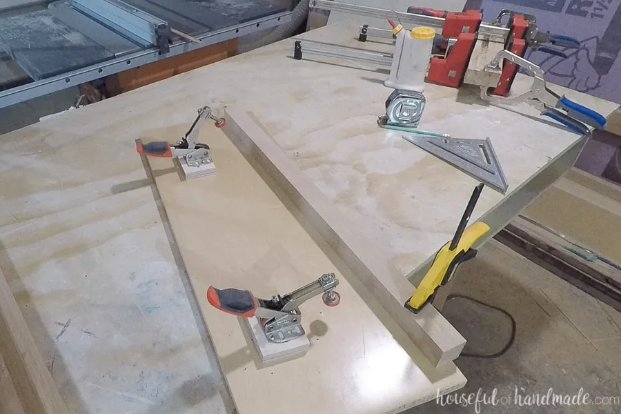 2x2 leg piece clamped to plywood to make a tapered leg jig.