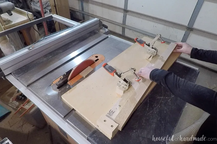 2x2 clamped into the jig sitting on the table saw.