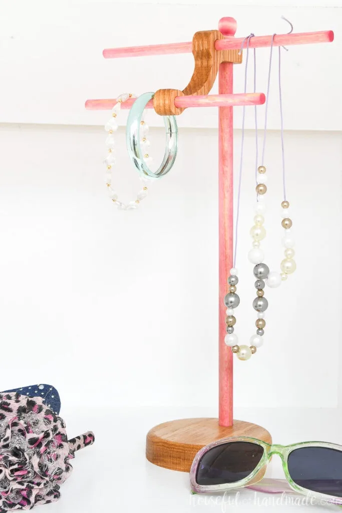 Pink stained dowels and oak DIY necklace stand.
