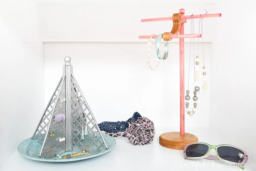 Two DIY jewelry holders in a closet displaying kids jewelry.