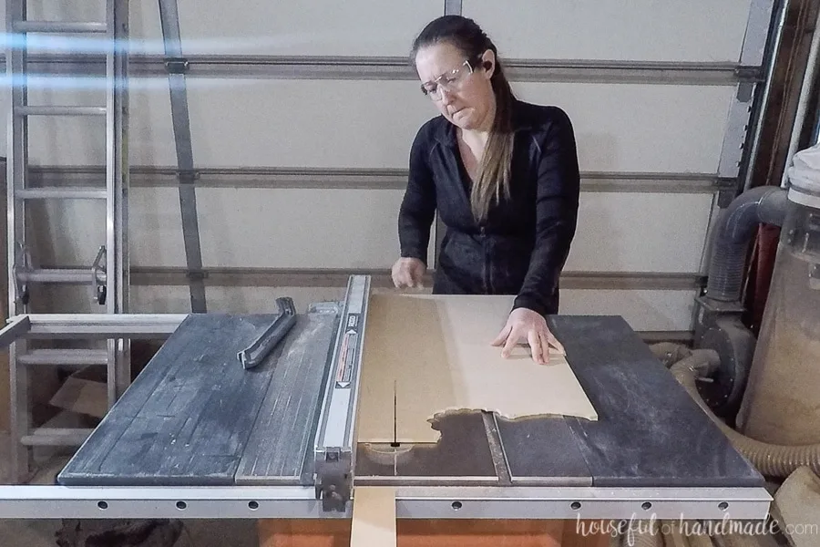 Using a table saw to rip sheets of 1/4" MDF into strips for the dividers.