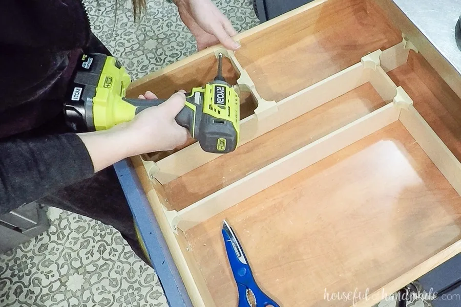 Securing the end cap clip to the inside of the drawer with a screw. 