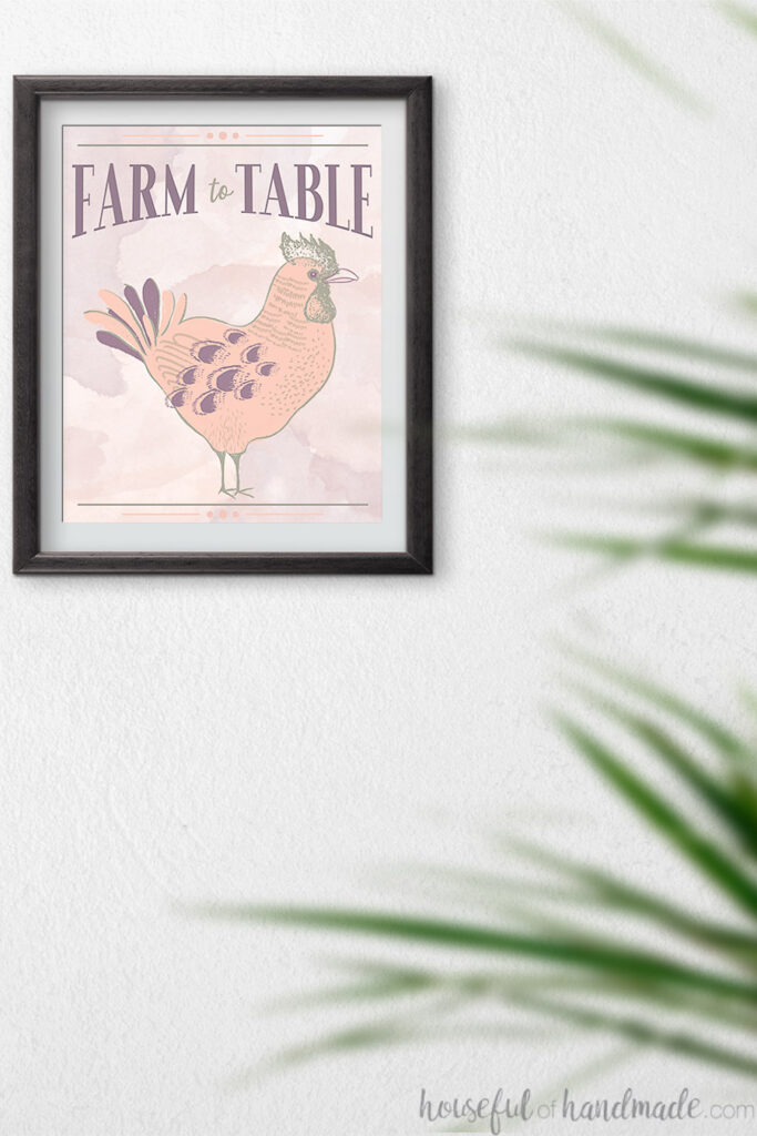 Farm to table spring printable hanging in a frame on the wall behind a plant.